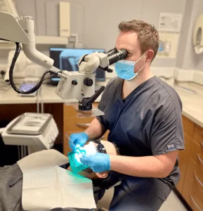 Dr Jonathan Skidmore performing Root Canal Treatment using a microscope