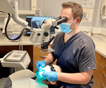 Dr Jonathan Skidmore carrying out a root canal treatment under microscope magnification